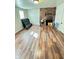 Open living area featuring a brick fireplace and hardwood flooring at 4144 Richelieu Rd, Indianapolis, IN 46226