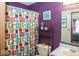 Bathroom featuring a shower with colorful curtain, purple walls and modern fixtures at 4238 Vestry Ct, Indianapolis, IN 46237