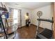 Bright bedroom featuring a desk and treadmill with wood-look flooring at 4238 Vestry Ct, Indianapolis, IN 46237