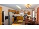Eat-in kitchen featuring stainless steel appliances, wood cabinets, and hardwood floors at 4238 Vestry Ct, Indianapolis, IN 46237