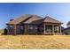 Exterior view of the rear of the home, displaying a brick facade and enclosed back porch at 4287 Prairie Falcon Dr, Zionsville, IN 46077