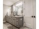 Modern bathroom featuring double vanity with granite countertop and ample storage space at 4287 Prairie Falcon Dr, Zionsville, IN 46077