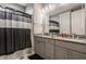 Well-lit bathroom featuring double vanity, granite countertops, and stylish shower curtain at 4287 Prairie Falcon Dr, Zionsville, IN 46077