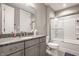 Bathroom features a granite countertop vanity, framed mirror, and tiled shower over tub at 4287 Prairie Falcon Dr, Zionsville, IN 46077