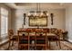 Elegant dining room featuring a modern chandelier, neutral colors, and a beautiful area rug at 4287 Prairie Falcon Dr, Zionsville, IN 46077