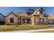 Striking home featuring a stone and brick exterior, gabled rooflines, covered porch, and manicured front lawn at 4287 Prairie Falcon Dr, Zionsville, IN 46077