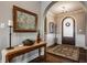 Elegant foyer showcasing hardwood floors, an arched entryway, a console table with decor, and a stylish rug at 4287 Prairie Falcon Dr, Zionsville, IN 46077