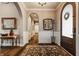 Refined foyer featuring dark wood floors, an arched doorway, elegant decor, and a patterned area rug at 4287 Prairie Falcon Dr, Zionsville, IN 46077