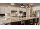 Updated kitchen featuring white cabinets, stainless steel appliances, and spacious granite countertops with barstool seating at 4287 Prairie Falcon Dr, Zionsville, IN 46077