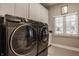 Laundry room showcasing new Samsung washer and dryer and ample storage at 4287 Prairie Falcon Dr, Zionsville, IN 46077