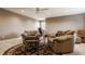 Living room showcases two oversized leather chairs with a round carpet and ceiling fan at 4287 Prairie Falcon Dr, Zionsville, IN 46077