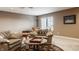 Cozy living room with comfortable seating, including leather chairs and ample natural light at 4287 Prairie Falcon Dr, Zionsville, IN 46077
