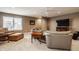 Large living room features comfortable seating with a large window and entertainment center at 4287 Prairie Falcon Dr, Zionsville, IN 46077