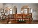 Living room with tray ceilings, arched doorways, and a glimpse of the elegant dining room beyond at 4287 Prairie Falcon Dr, Zionsville, IN 46077