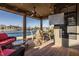 Screened in patio featuring water views, a ceiling fan, and comfortable seating at 4287 Prairie Falcon Dr, Zionsville, IN 46077