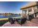 Stamped patio featuring comfortable swivel chairs and lake views in the backyard at 4287 Prairie Falcon Dr, Zionsville, IN 46077