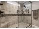 Walk-in shower featuring decorative tile, rainfall shower head, bench, and glass door at 4287 Prairie Falcon Dr, Zionsville, IN 46077