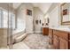 Bright bathroom featuring double vanities, a soaking tub, and a separate shower for relaxation at 438 E Vermont St, Indianapolis, IN 46202