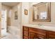 Bright bathroom with white trim, wooden vanity, and a decorative mirror at 438 E Vermont St, Indianapolis, IN 46202