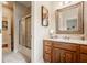 Bathroom featuring a wood vanity with a decorative mirror and shower room at 438 E Vermont St, Indianapolis, IN 46202