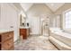 Bathroom with double vanity, tiled floors, a glass door shower and soaking tub, offering a spa-like experience at 438 E Vermont St, Indianapolis, IN 46202
