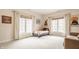 Bright, carpeted bedroom with multiple windows, stylish decor, and a cozy bed at 438 E Vermont St, Indianapolis, IN 46202