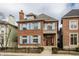 Attractive two-story brick home with light blue shutters, a cozy balcony, and a welcoming entrance at 438 E Vermont St, Indianapolis, IN 46202