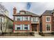 Charming two-story brick home featuring light blue shutters and a well-manicured front yard at 438 E Vermont St, Indianapolis, IN 46202