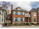 Beautiful two-story brick home with light blue shutters, a classic chimney, and manicured landscaping at 438 E Vermont St, Indianapolis, IN 46202
