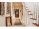 Inviting foyer features hardwood floors, staircase, and a view into the kitchen at 438 E Vermont St, Indianapolis, IN 46202
