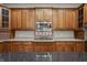 Bright kitchen with stone countertops, tile backsplash, and wooden cabinets at 438 E Vermont St, Indianapolis, IN 46202
