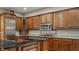 Kitchen featuring stainless appliances, wood cabinets, and stone countertops at 438 E Vermont St, Indianapolis, IN 46202