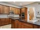 Modern kitchen with wood cabinets and stainless steel oven and microwave at 438 E Vermont St, Indianapolis, IN 46202