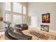 Living room features hardwood floors, tall windows, and a comfortable seating area at 438 E Vermont St, Indianapolis, IN 46202
