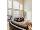 Bright living room featuring tall windows, hardwood floors, and a comfortable seating area at 438 E Vermont St, Indianapolis, IN 46202