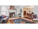 Spacious living room with a fireplace, hardwood floors, and an open view to the dining area at 438 E Vermont St, Indianapolis, IN 46202