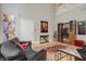 Bright living room featuring hardwood floors, modern decor, and a comfortable black leather sofa at 438 E Vermont St, Indianapolis, IN 46202