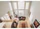 Aerial view of the living room showcasing hardwood floors, a wall of windows, and bright natural light at 438 E Vermont St, Indianapolis, IN 46202