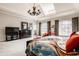 Well-lit main bedroom with a tray ceiling, chandelier, and comfortable furnishings at 438 E Vermont St, Indianapolis, IN 46202