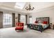 Spacious main bedroom with a skylight, statement chandelier, and elegant furnishings at 438 E Vermont St, Indianapolis, IN 46202