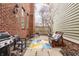 Charming patio area with comfortable seating, a grill, and a colorful rug at 438 E Vermont St, Indianapolis, IN 46202
