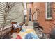 Inviting outdoor patio area with brick wall, seating, grill, and colorful rug at 438 E Vermont St, Indianapolis, IN 46202