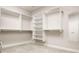 Bright walk-in closet with custom white shelving, hanging rods, and ample storage space for organization at 438 E Vermont St, Indianapolis, IN 46202