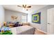 Comfortable bedroom with a cozy bed, desk, window with natural light, and ceiling fan at 4618 Angelica Dr, Indianapolis, IN 46237