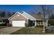 Charming home featuring a two-car garage, brick facade, and manicured front lawn at 4618 Angelica Dr, Indianapolis, IN 46237