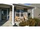 Inviting front porch with cozy seating, brick accents, and charming curb appeal at 4618 Angelica Dr, Indianapolis, IN 46237