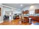 Open-concept kitchen with an eat-in island, modern appliances, and laminate wood floors at 4618 Angelica Dr, Indianapolis, IN 46237