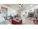 Comfortable living room featuring a stone fireplace, ceiling fan, and wood flooring at 4618 Angelica Dr, Indianapolis, IN 46237