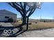 View of a large, sunny backyard with a shed, detached garage, and basketball hoop at 4823 S State Road 75, Jamestown, IN 46147