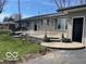 Spacious backyard patio with steps, a bench swing and landscaping at 4823 S State Road 75, Jamestown, IN 46147